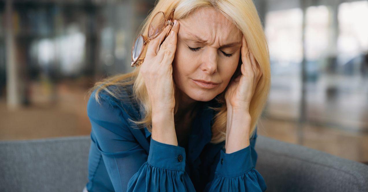 Headache, stress, fatigue. Mature caucasian business woman closed her eyes because of headache