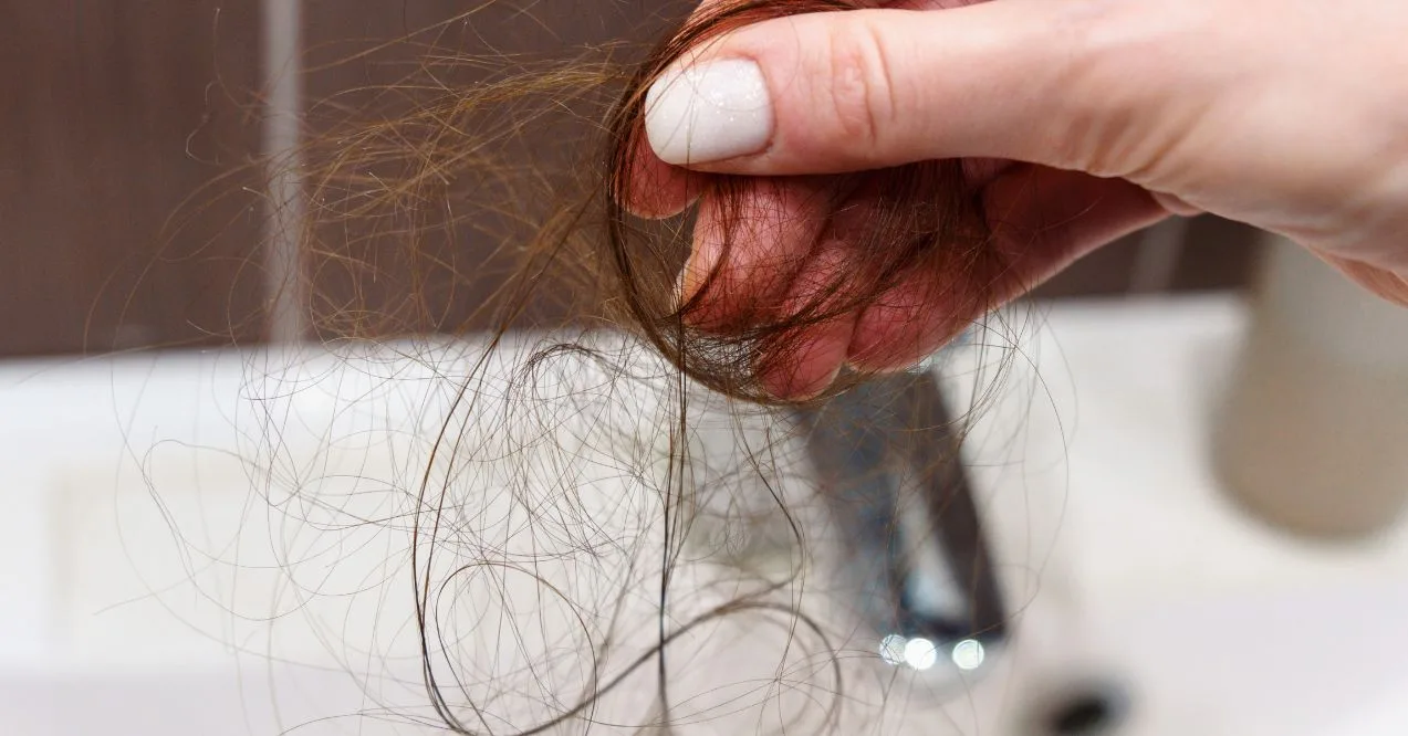 Close up reveals the challenges of an individual confronting hair loss. Selective focus