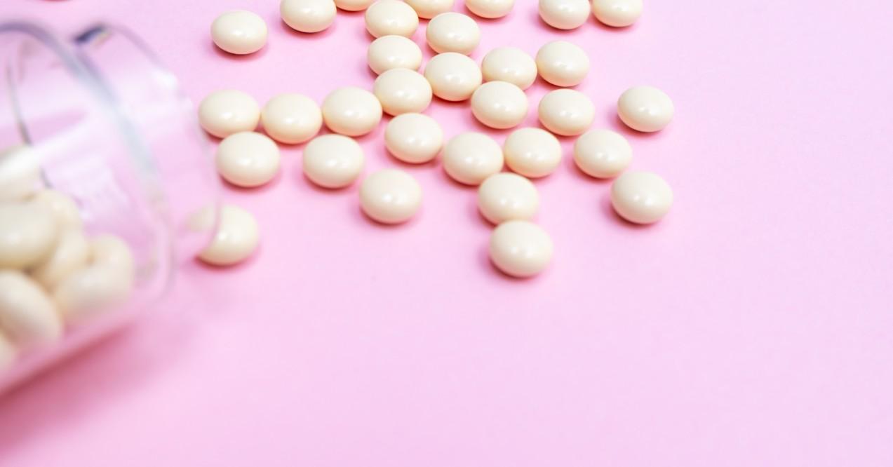 Spilled Tablet Pill on a Pink Background