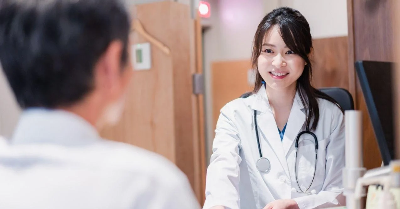 Female doctor examining a male patient in the clinic