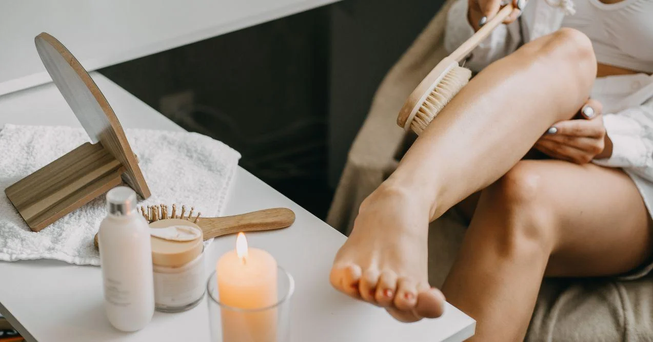 Woman dry brushing her leg