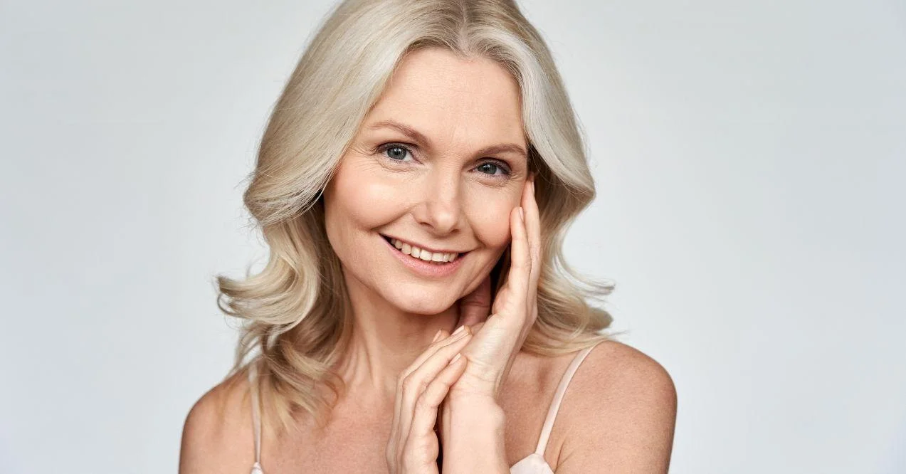 woman is holding a hand on her cheek