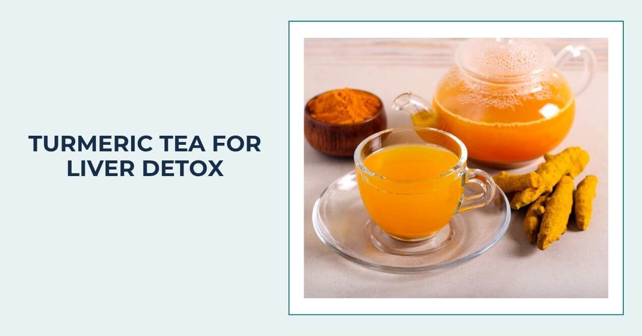 Glass cup of turmeric tea with turmeric roots and powder nearby.