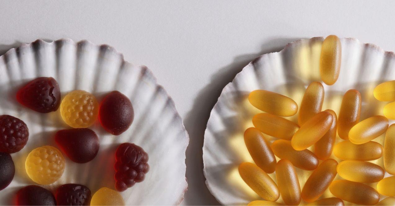 chewable supplements, nutritional gummies, edible health concept. colorful marmalades and omega 3 vitamins on shell on white background.