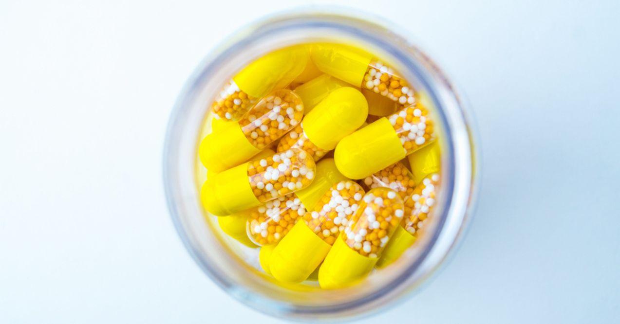Open Container with Vitamin D3 and K2 capsules