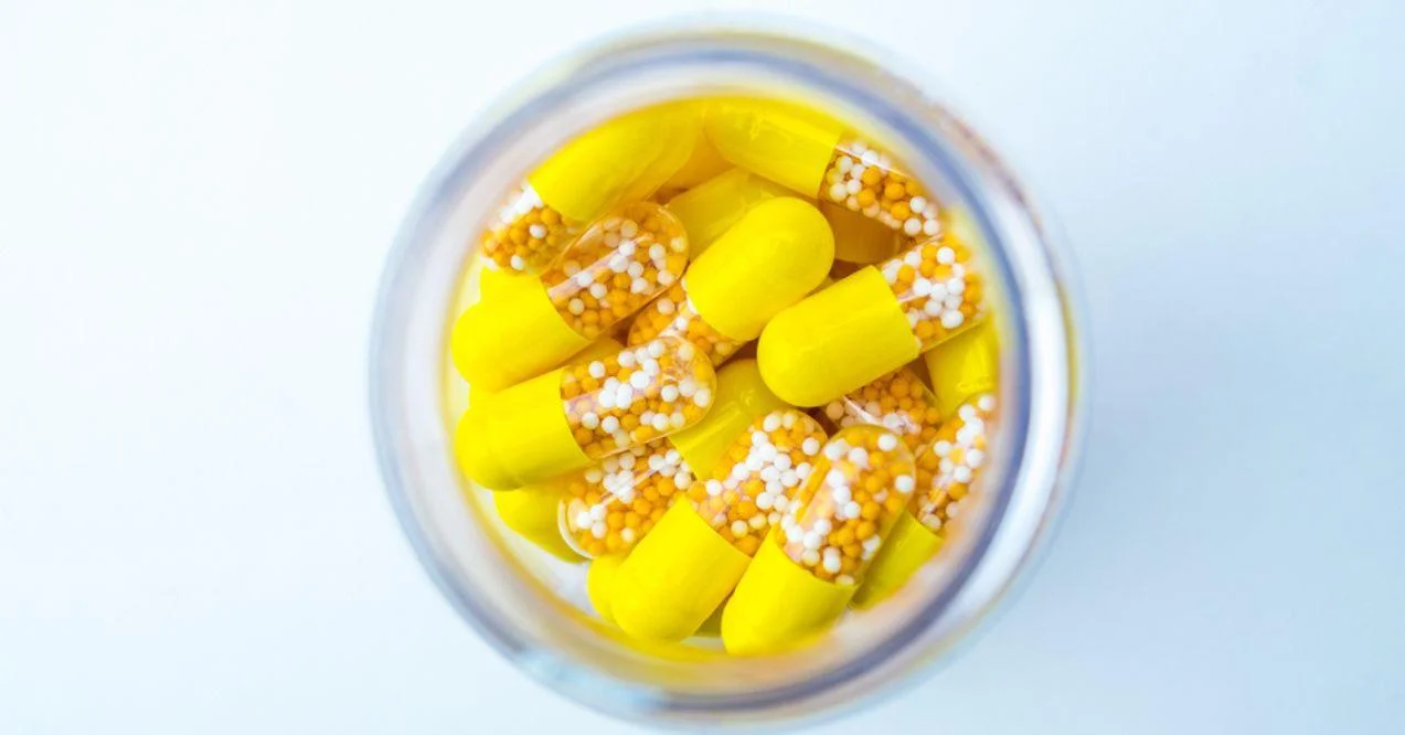 Open Container with Vitamin D3 and K2 capsules