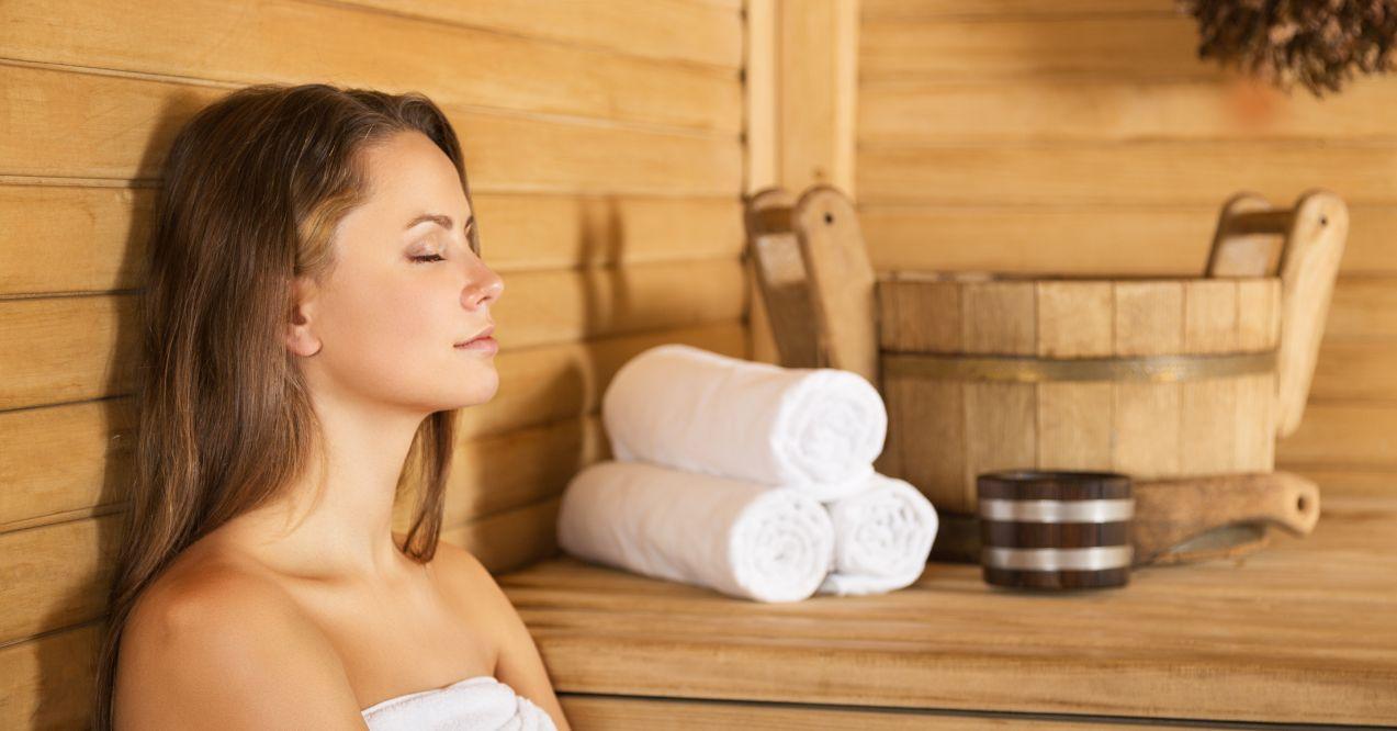 a woman is sitting in a sauna