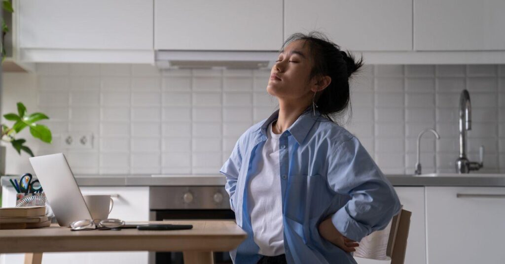 a woman is sitting in the kitchen at table with chronic fatigue