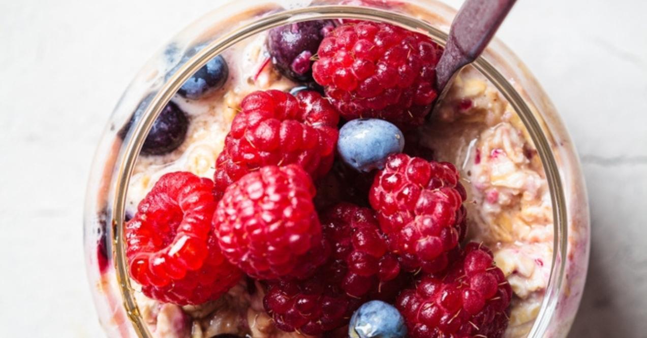 Oatmeal with berries, chia and maple syrup in jar