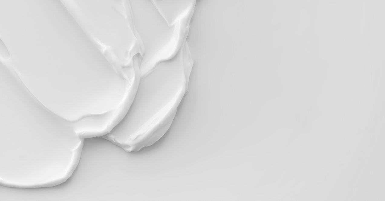Moisturizer lotion smeared on a white background