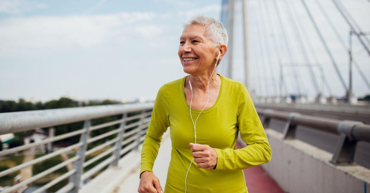 older woman exercising with headphones