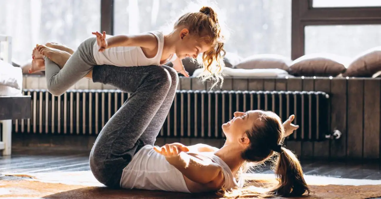 Mother and daughter doing yoga at home