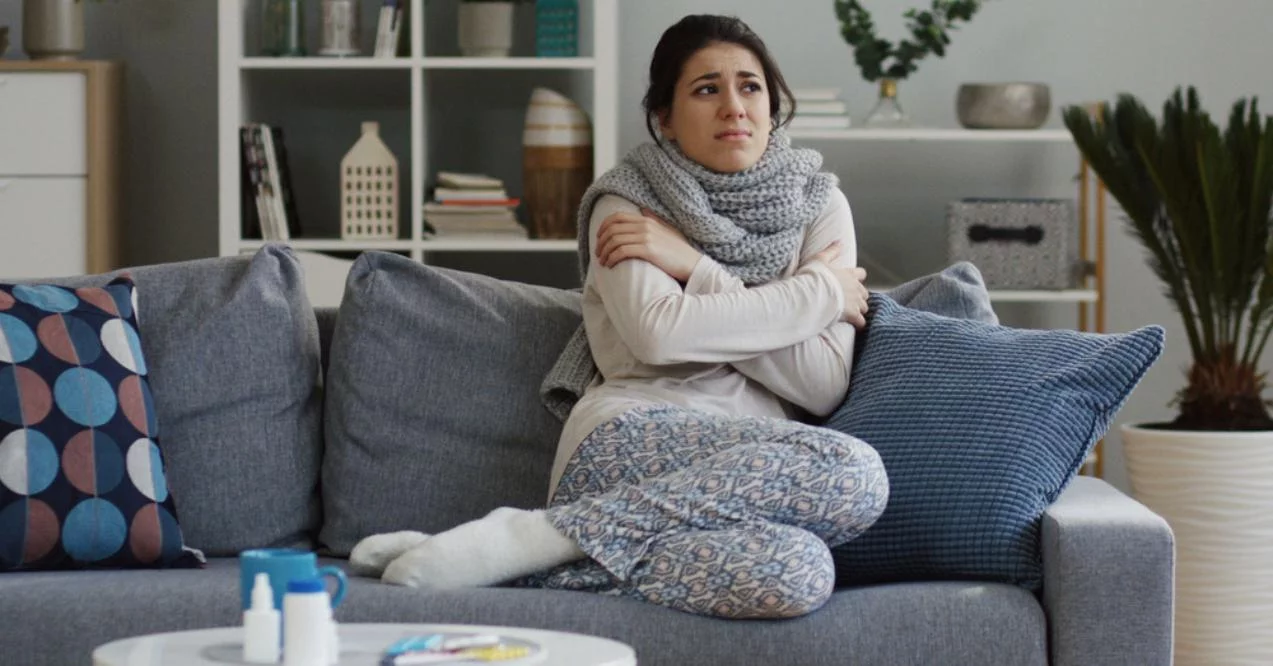 Woman in the warm scarf shivering