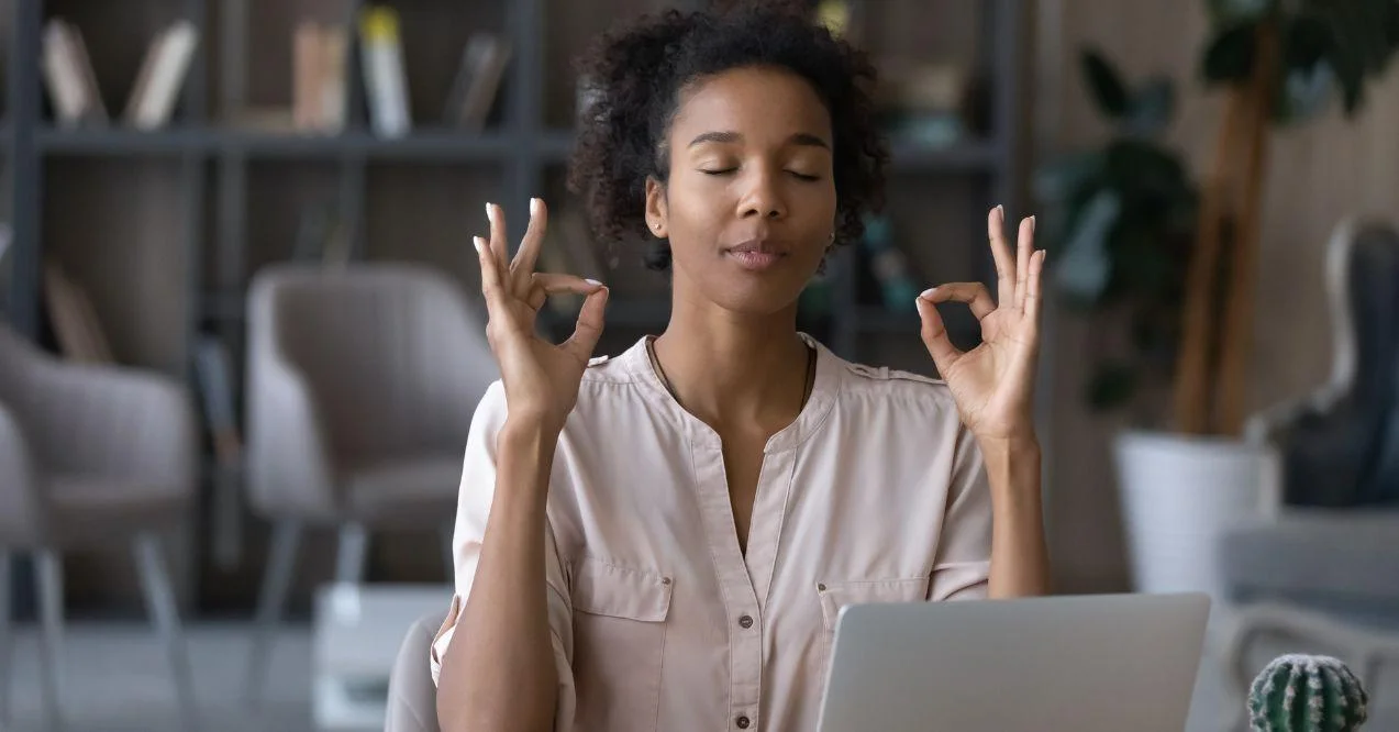 a woman is making the ok sign with both of her hands