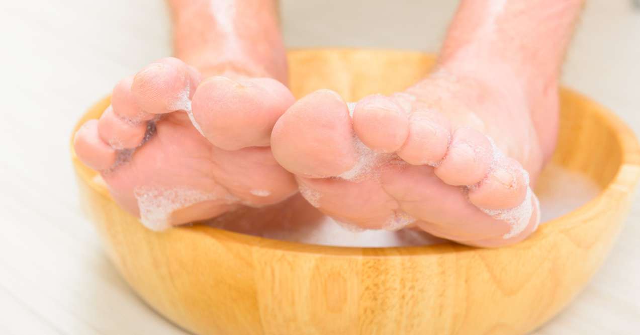 Male feet in a bowl with water