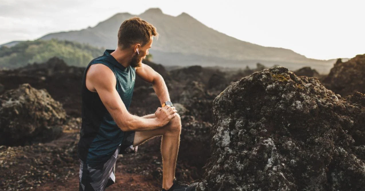 Man stretching and warming-up for trail running outdoors