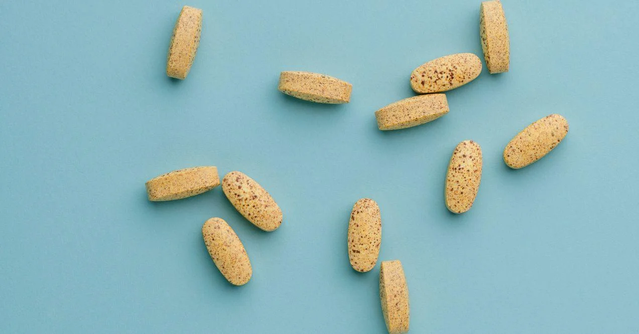 Vitamin B complex capsules on a bright blue background