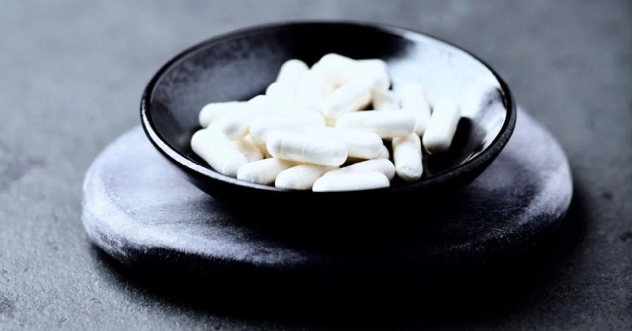 Zinc capsules on dark stone background