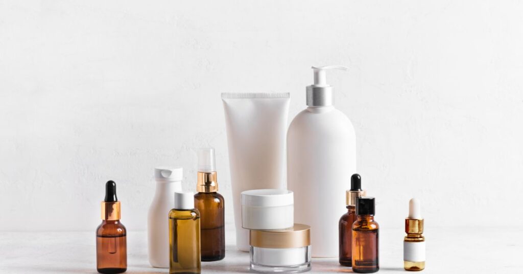 collection of skincare products in various bottles and jars neatly arranged against a white background