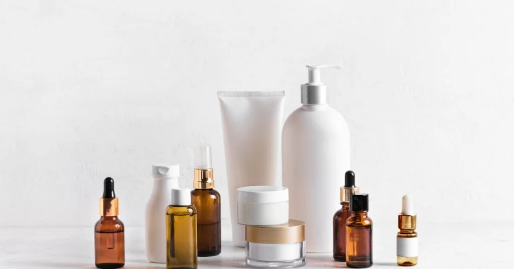 collection of skincare products in various bottles and jars neatly arranged against a white background