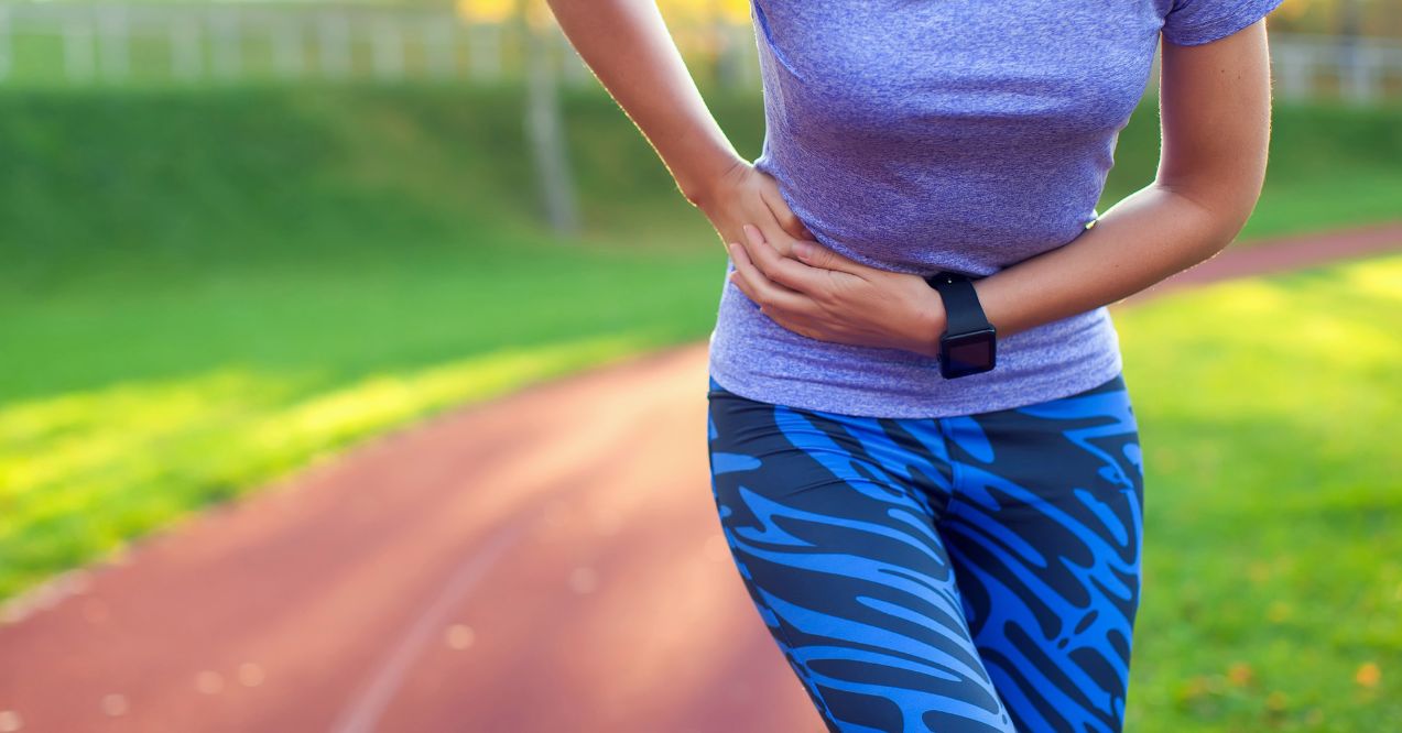 Side stitch - woman runner side cramps after running. Jogging woman with stomach side pain after jogging work out. Female athlete. Is it liver pain?