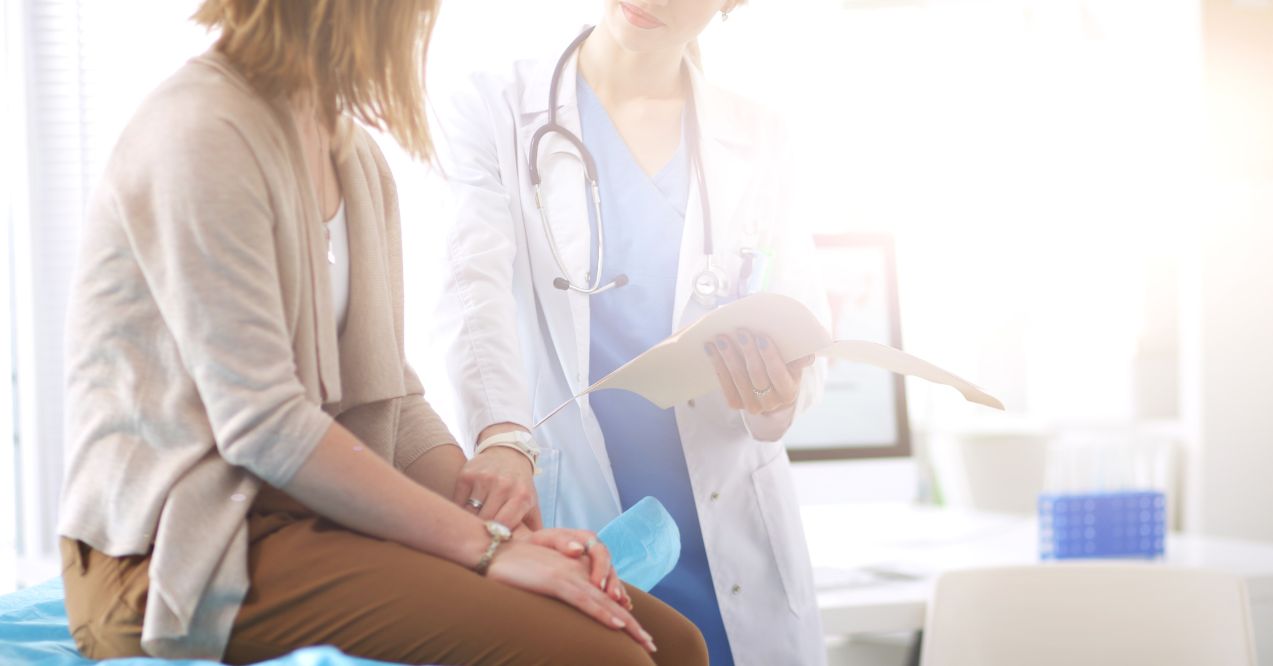 A doctor consulting a patient about foot health or treatment options.