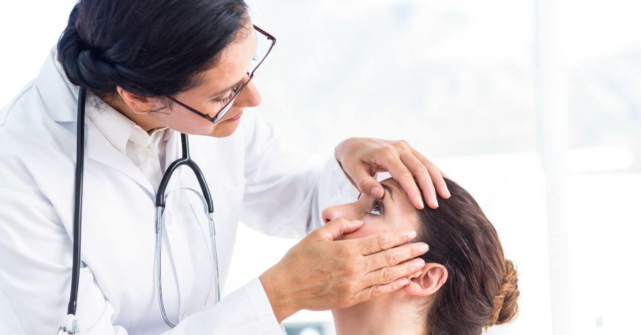 Doctor performing an eye examination on a female patient.