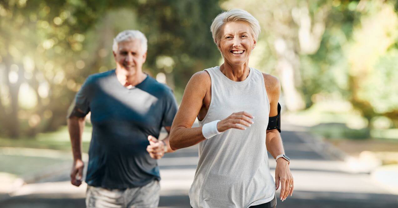 Older couple jogging outdoors for better overall health and eyesight.