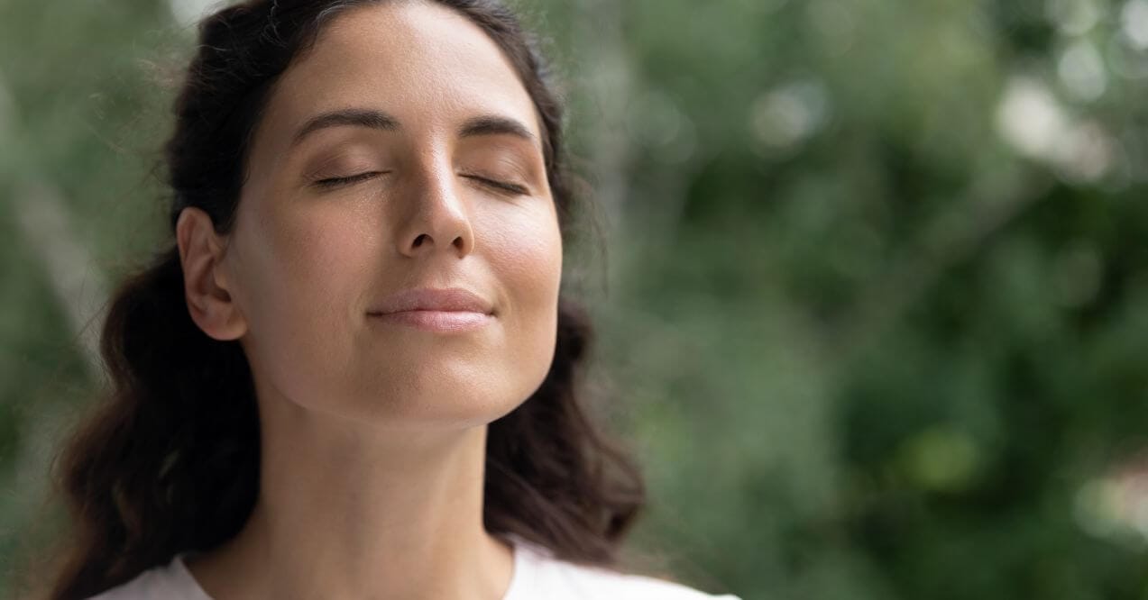 Woman resting with eyes closed, promoting eye health through relaxation.