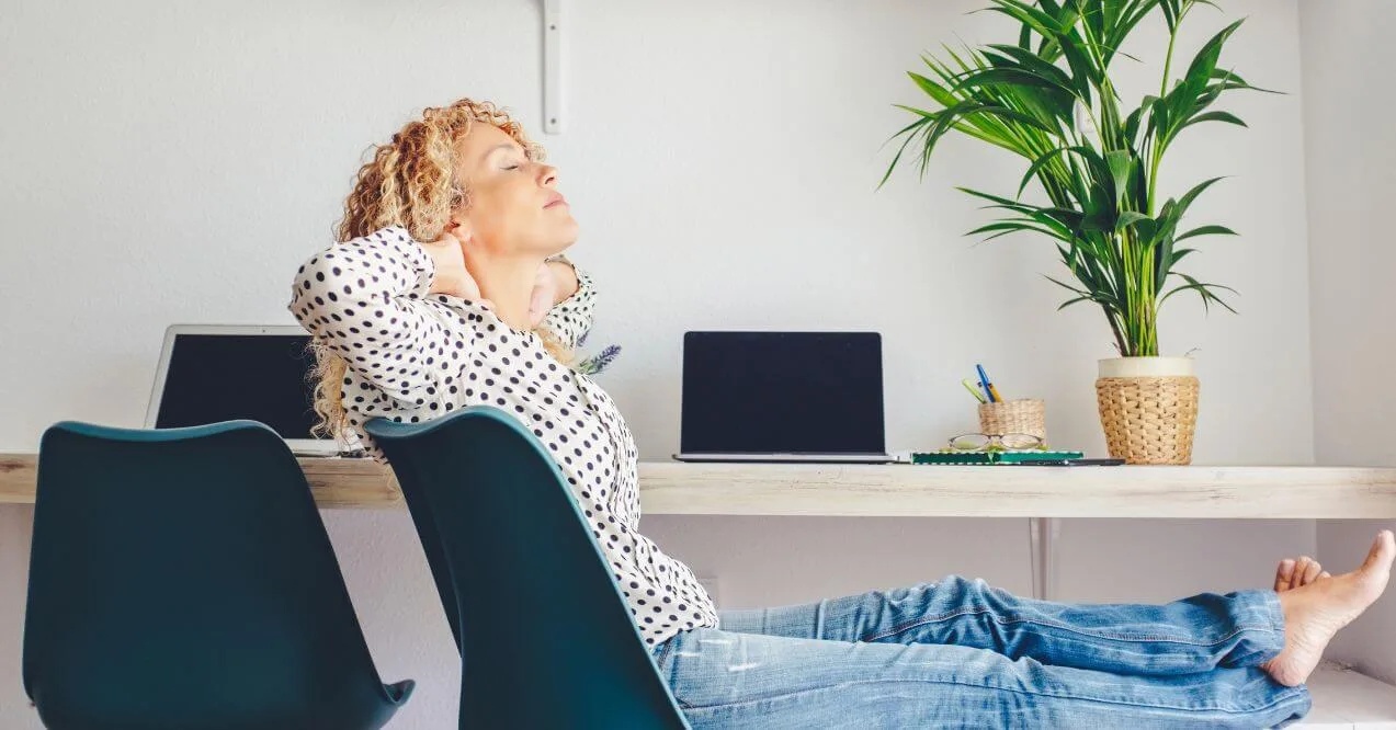 Woman relaxing at desk to combat stress.