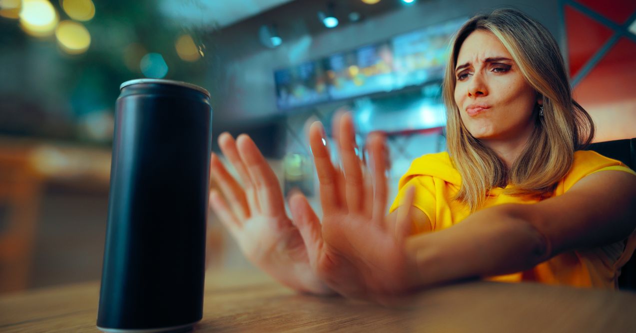 A woman refusing an energy drink, highlighting healthy substitutes for energy drinks.