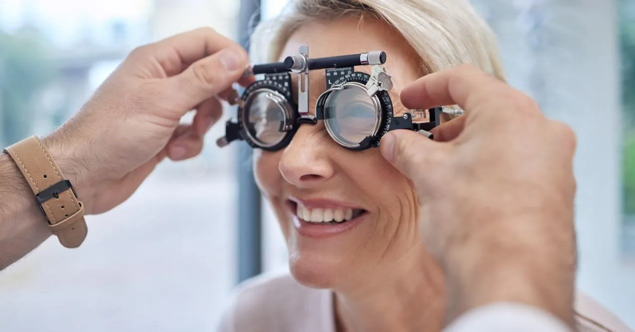 Eye exam with a patient wearing trial frames during vision check, asking how to improve eyesight.