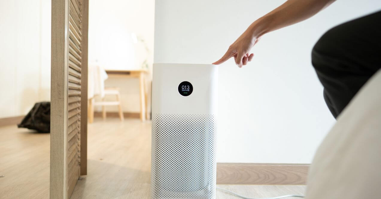 Using an air purifier to reduce pollutants in indoor air.