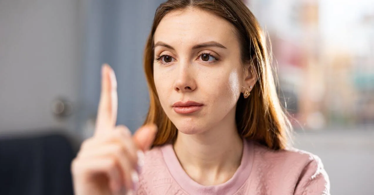 Woman focusing on her finger as part of an eye exercise.