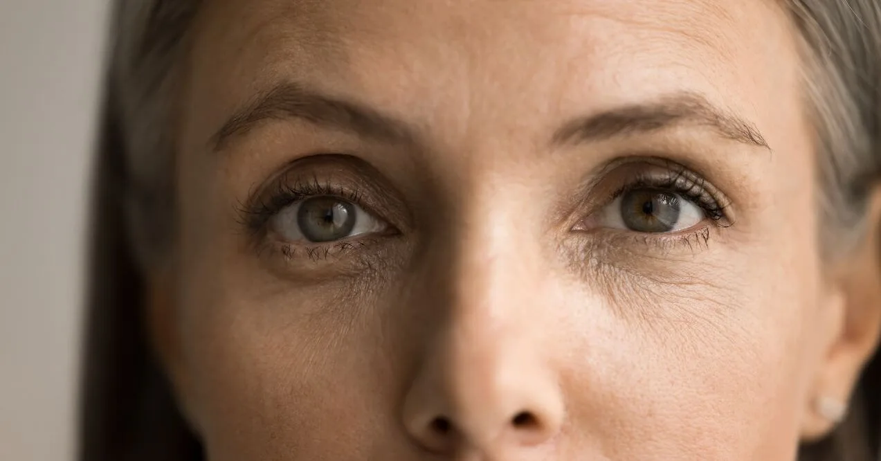 Close-up of an older woman’s eyes with visible fine lines.