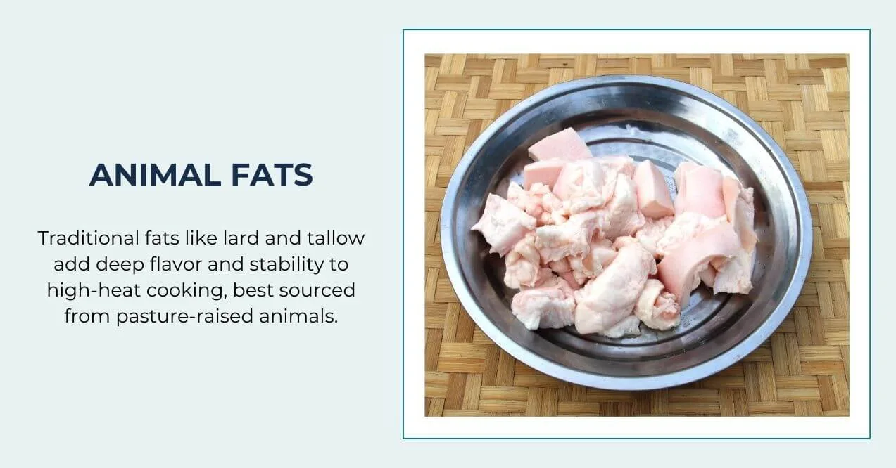 A metal bowl filled with raw animal fat pieces on a woven mat.