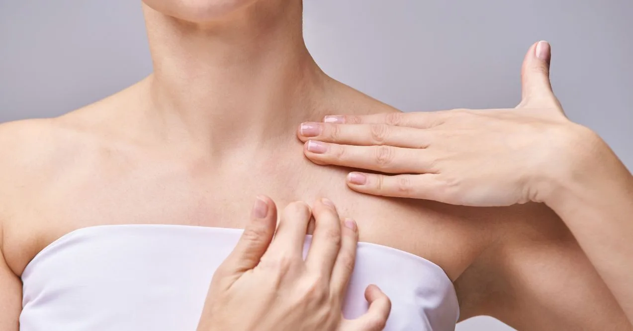 Woman gently massaging her neck and collarbone area