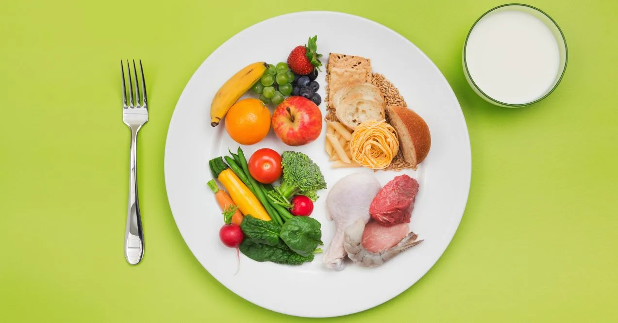 A plate with a variety of healthy foods, including fruits, vegetables, grains, and protein.