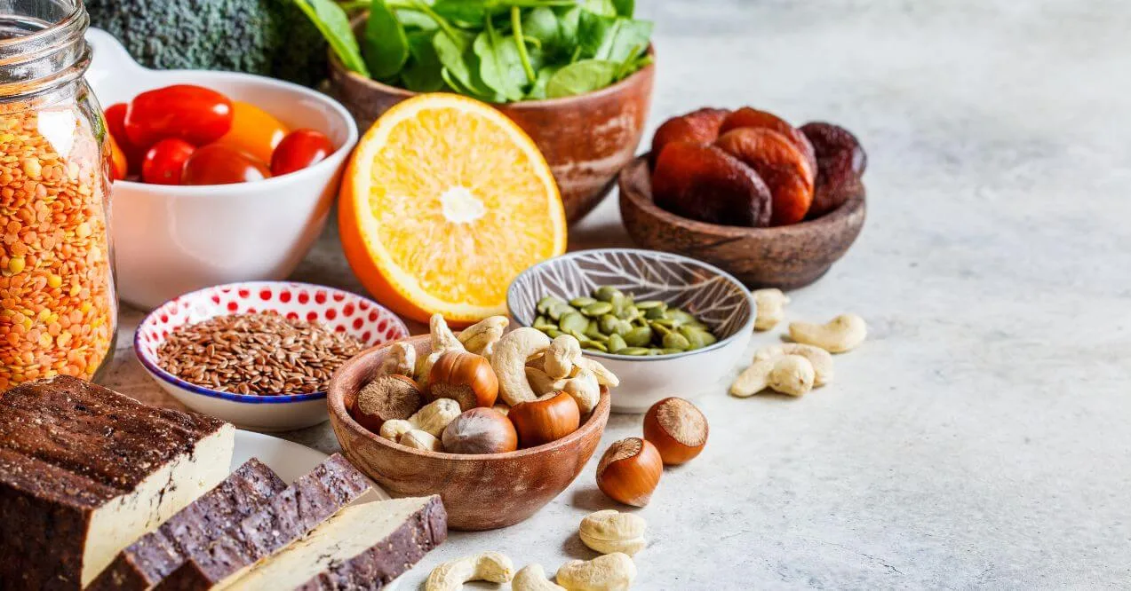 A selection of vegan iron sources including nuts, seeds, and legumes.