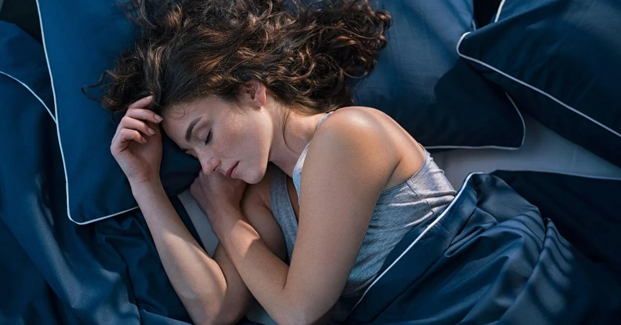 Woman sleeping soundly in bed, representing a question: what is core sleep?