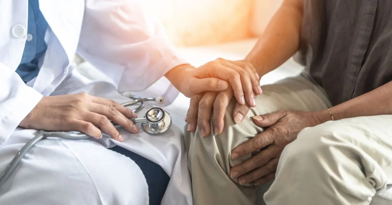 Doctor holding patient's hand to explain nerve health in parkinson's symptoms