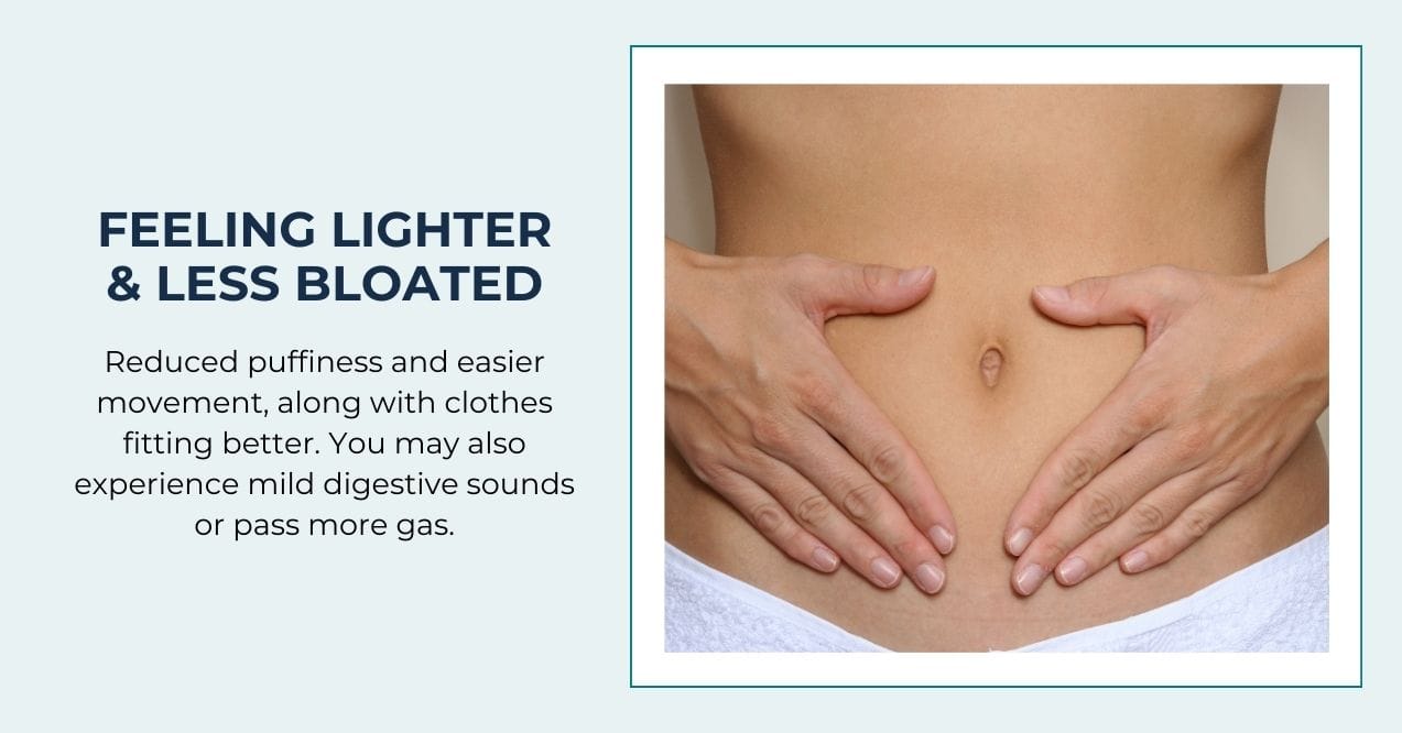 Hands on the abdomen of a woman showing feeling lighter and less bloated.