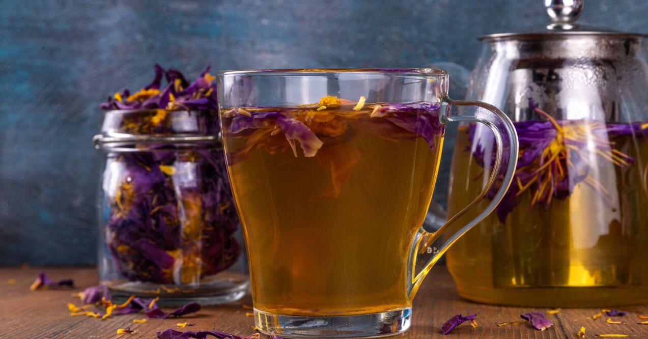 Brewing process of blue lotus tea with petals in the water.