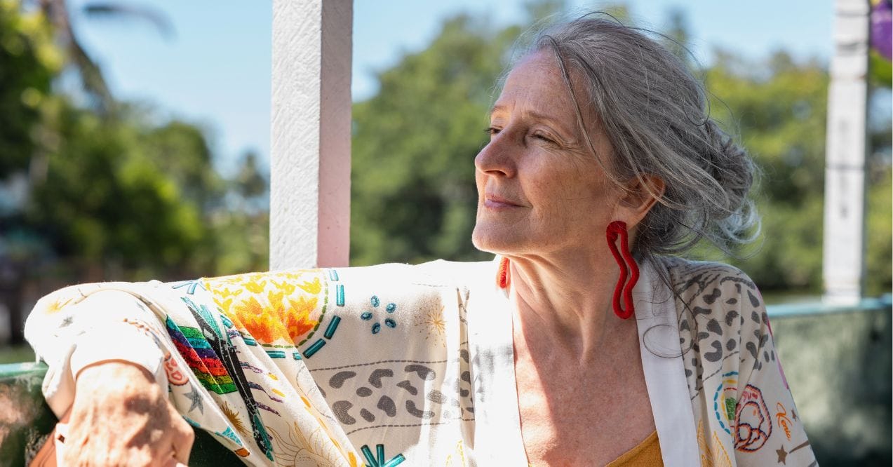 An older beautiful woman gazing to the horizon thinking about something
