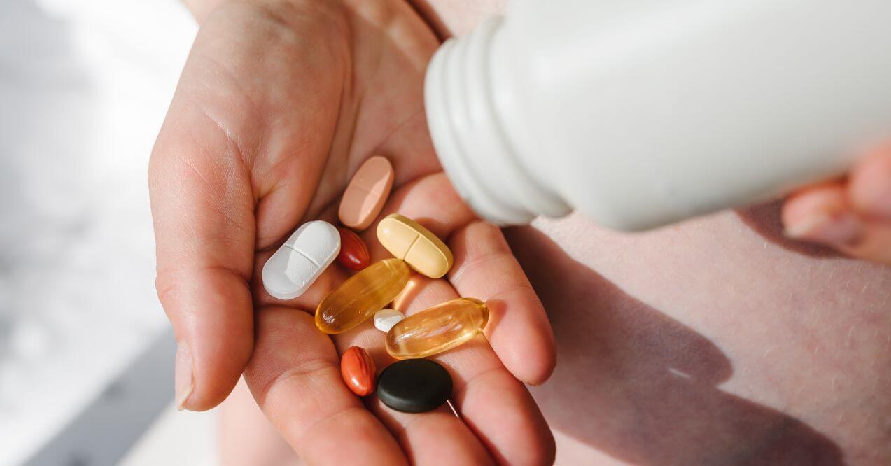 Close-up of various holistic health supplements in a person's hand
