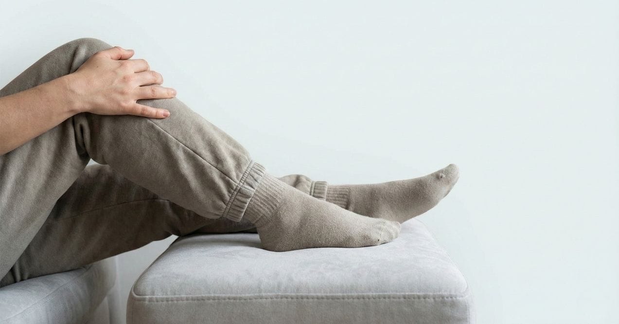 Person resting with legs elevated on a couch