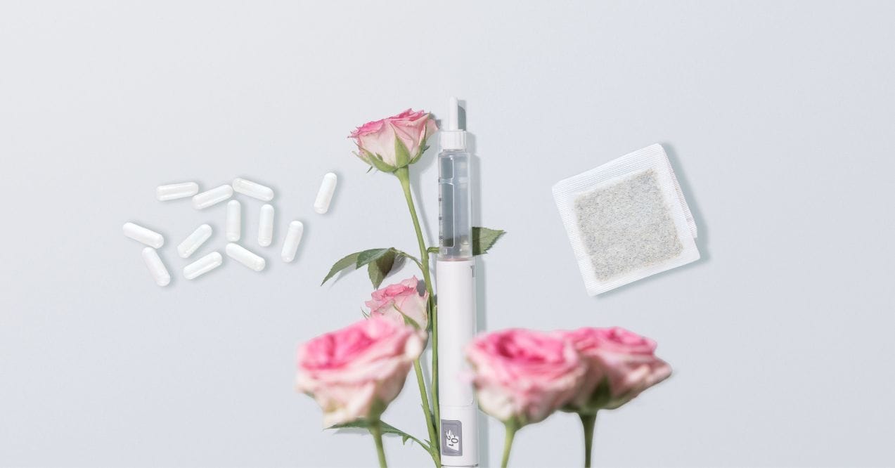 GLP-1 concept image with injector pen, capsules, tea bag, and pink roses